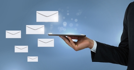 Digital composite of Envelope letter messages and hand using tablet