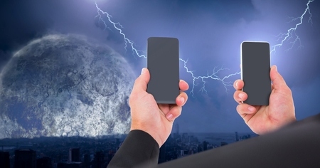 Digital composite of Lightning strikes and businessman holding two phones connecting