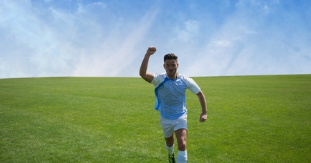 Digital composite of Soccer player on grass with skyの写真素材