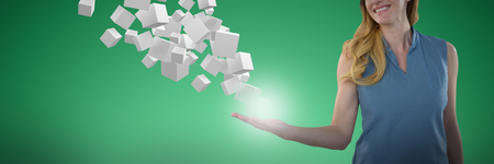 Woman presenting object against abstract green backgroundの写真素材