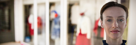Business woman portrait against shops in shopping mallの写真素材