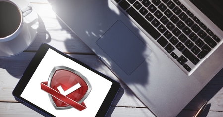 Digital composite of Quality correct tick and  security protection shield on laptopの写真素材