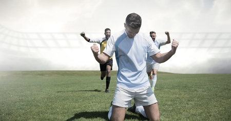 Digital composite of Soccer players celebrating on grassの写真素材
