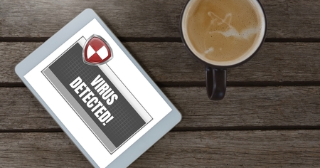 Digital composite of Antivirus security protection shield detection on tablet with coffee