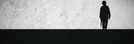 Grey background against full length of military posingの写真素材