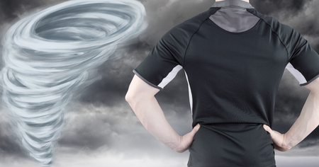 Digital composite of Tornado twister painted and dark sky with sport fitness manの写真素材