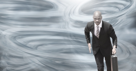 Digital composite of Tornado twisters painted and dark sky with businessman runningの写真素材