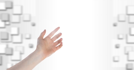 Digital composite of hand touching white blank space glow with squaresの写真素材