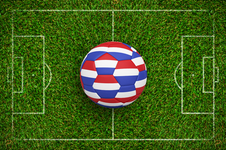 Football in holland colours  against green grassの写真素材
