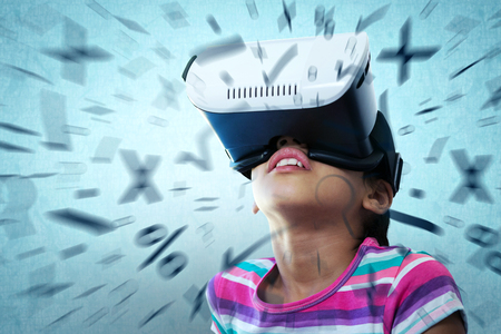Close up of girl using virtual reality simulator against blue backgroundの写真素材