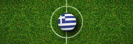 Football in greece colours against green grassの写真素材