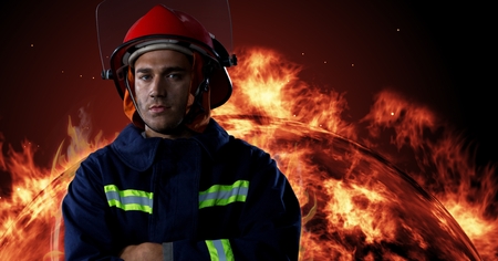 Digital composite of Firefighter in front of burning fire