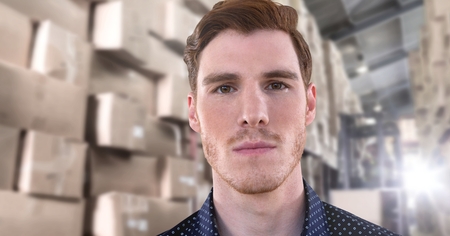 Digital composite of Businessman serious in warehouse with boxes