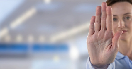 Digital composite of Woman holding hand to stopの写真素材