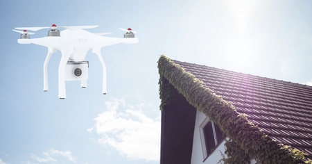Digital composite of Drone flying by house with cameraの写真素材