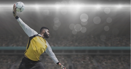 Digital composite of Soccer goalkeeper throwing ball in stadiumの写真素材