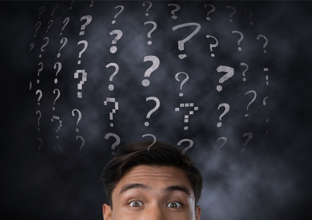 Digital composite of Surprised Man with question marks above his headの写真素材