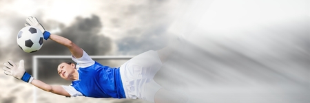 Digital composite of Soccer goalkeeper saving ball in goal with transitionの写真素材