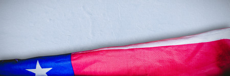 Creased US flag against full frame shot of rough wallの写真素材