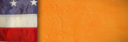 Creased US flag against full frame shot of textured wall