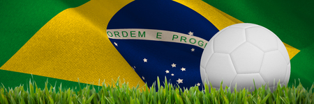 Digitally generated white leather football  against close-up of grass matの写真素材