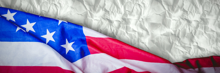 US flag against crumpled white pageの写真素材