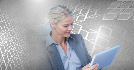 Digital composite of Woman using laptop with geometric transitionの写真素材