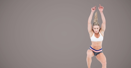 Digital composite of Athletic fitness woman jumping with blank brown backgroundの写真素材