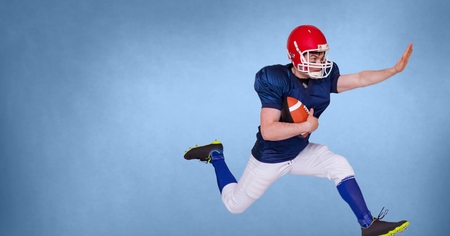 Digital composite of American football player with blank blue background