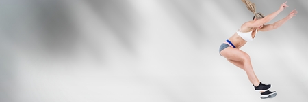 Digital composite of Athletic fit jumping woman with motion transitionの写真素材