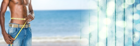 Digital composite of Man measuring weight with measuring tape on waist on Summer beach with...