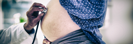 Cropped image of doctor examining pregnant woman in clinicの写真素材