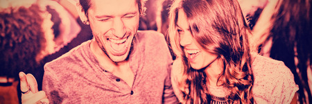 Happy friends with mouth open enjoying at nightclubの写真素材