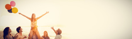 Happy woman with friends holding balloons at beach