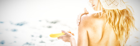 Woman applying sunscreen on a sunny day