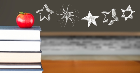 Digital composite of Star drawings with apple on books in schoolの写真素材