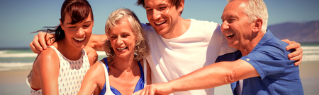 Cheerful family looking at mobile phone during sunny day