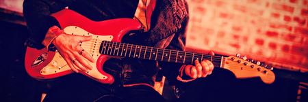 Young man playing guitar in pub