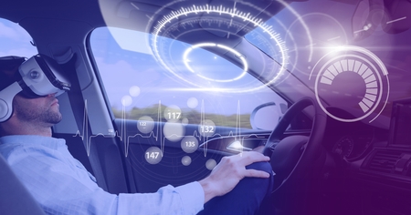 Digital composite of Man driving in car with heads up display interface and virtual reality headset