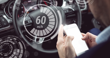 Digital composite of Man driving in car with heads up display interface and phone