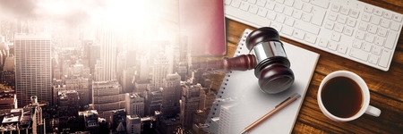 Digital composite of Gavel and keyboard with notepads and coffee on desk with transition