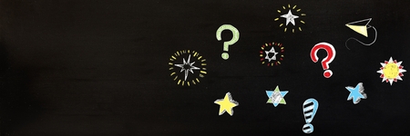 Digital composite of Question marks and stars drawing on blackboard