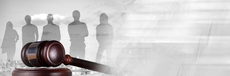 Digital composite of Gavel and people silhouettes over city with transitionの写真素材