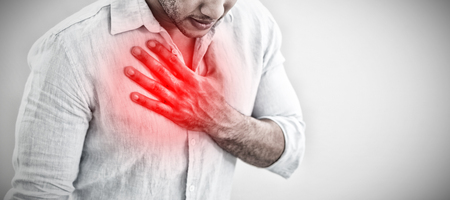 Casual young man with chest pain against highlighted painの写真素材