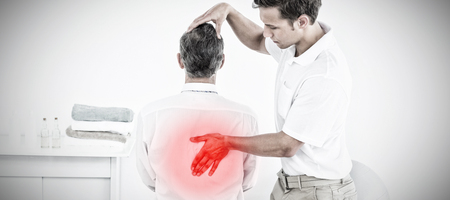 Highlighted pain against physical therapist massaging man backの写真素材
