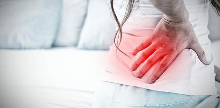 Highlighted pain against attractive woman with back painの写真素材