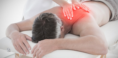 Highlighted pain against man receiving back massageの写真素材