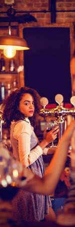 Jealous woman looking at couple flirting with each other in pub
