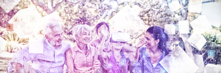 Digitally generated grey cubes floating  against girl using vr headset while sitting with her family