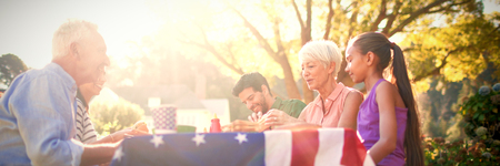 Happy family having a picnic on an american tableclotheの写真素材